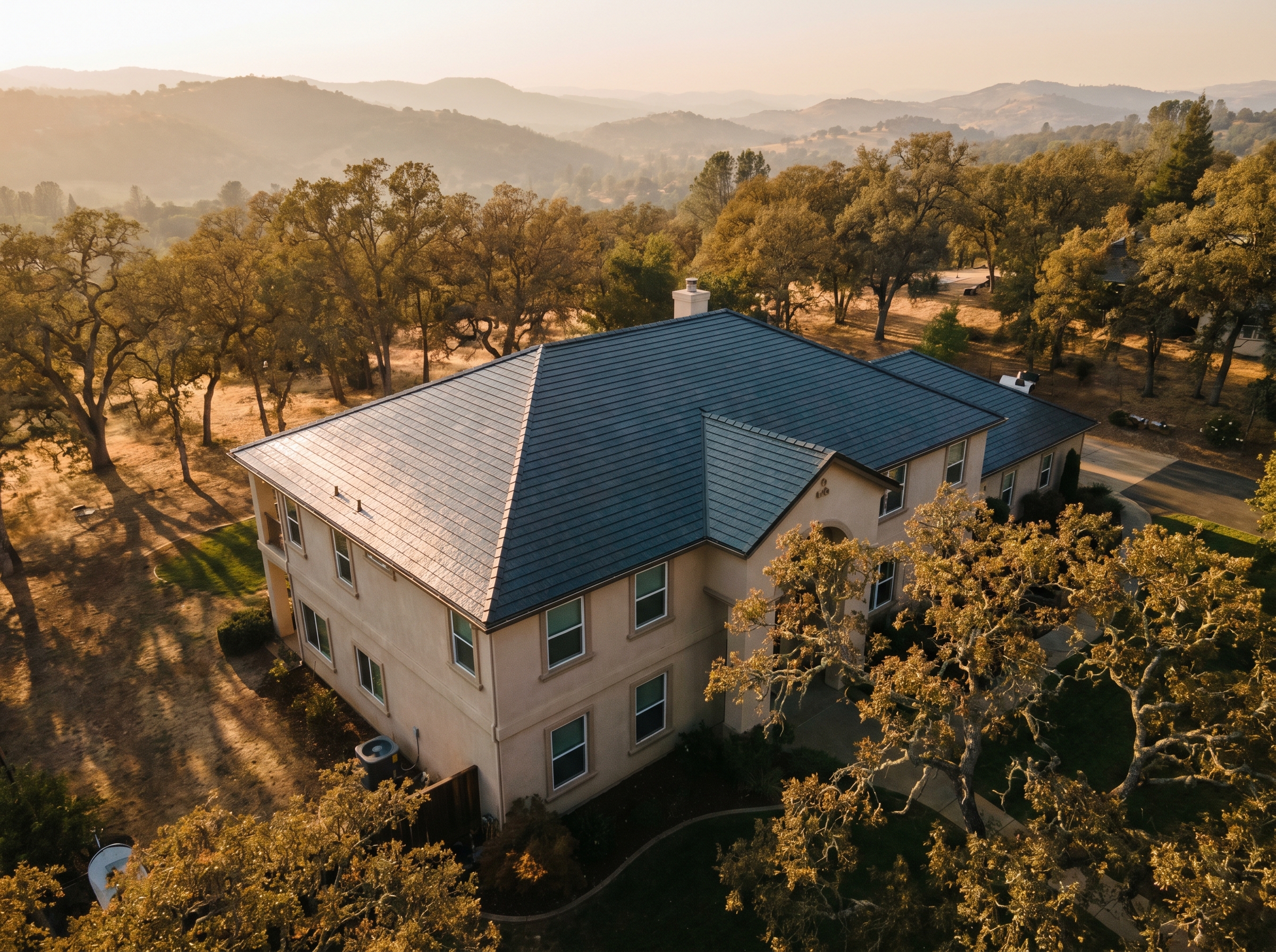 Drone aerial of a Tesla Solar Roof installation in El Dorado Hills at golden hour.